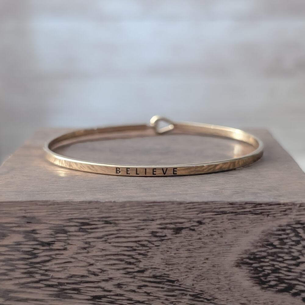 Gold Tone Believe Bangle Bracelet - 6.75"